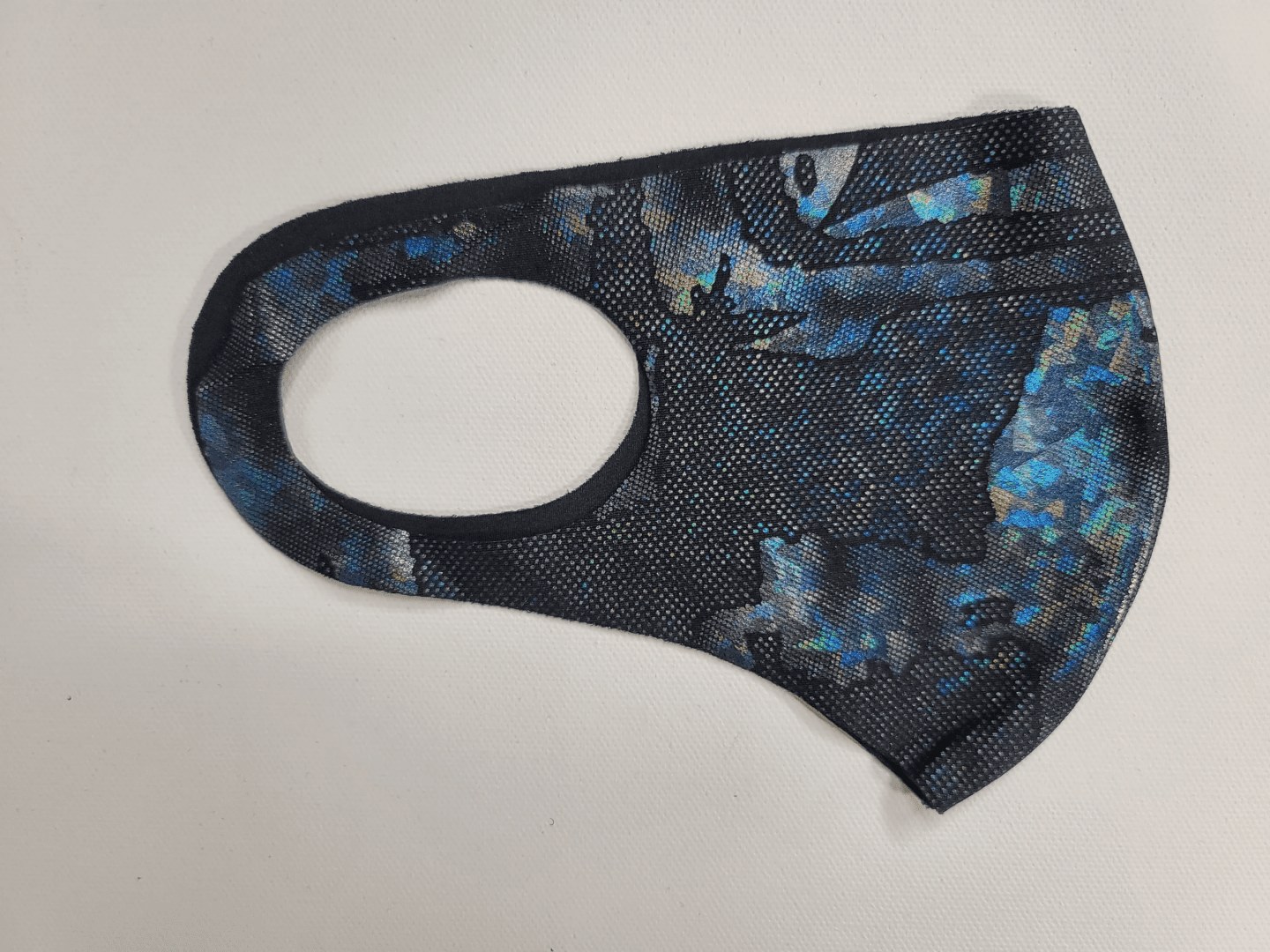 mask with a black and blue camoflauge pattern
